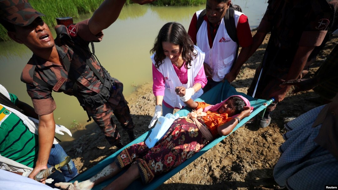 A pregnant Rohingya refugee who is in labor, is brought to a medical center on a stretcher after crossing the Bangladesh-Myanmar border in Palong Khali, near Cox's Bazar, Bangladesh, Nov. 3, 2017.