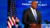 President-elect Joe Biden, left, listens as retired Army Gen. Lloyd Austin, Biden's choice to be secretary of defense, speaks during an event at The Queen theater in Wilmington, Del., Dec. 9, 2020. 