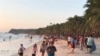 Visitors gather along the beach during sunset in Boracay island, Philippines, Friday, Oct. 26, 2018. Tourists sailed to the popular destination on the first day officials reopened the resort to visitors