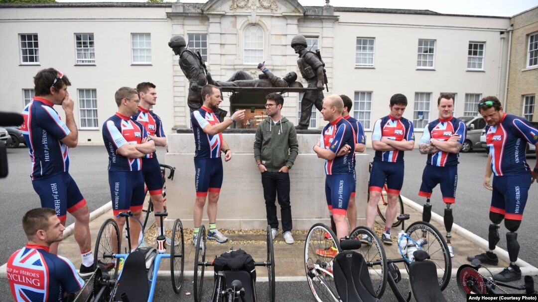 Cyclists and crew members talk with a cyclist about strategies in front of the Tedworth House recovery center in Britain. They are competing in the Race Across America for Help for Heroes. The military charity works with wounded veterans by providing treatment and career training. Left to right: Joe Townsend, Jaco van Gass, Robert James Donald Cromey-Hawke, Ryan Gray, Andrew Perrin, Mark Cavendish, Craig Preece, Stuart Croxford, Adam Clark, Micheal Swain and Josh Boggi. 