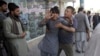 A shocked man shouts slogans against President Ghani after he ran out of the Shiite mosque during an ongoing attack, Kabul, Afghanistan, Aug. 25, 2017. 