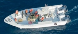 This image released by the U.S. Department of Defense on June 17, 2019 shows what the Navy says is the Islamic Revolutionary Guard Corps Navy after removing an unexploded mine from a tanker in the Strait of Hormuz.