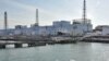 A US military barge carrying pure water (bottom) leaves the quay near Tokyo Electric Power Co.'s Fukushima Daiichi Nuclear Power Plant on April 4, 2011.