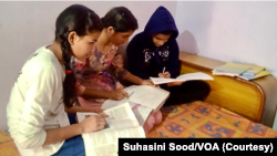 Pooja Sharma (in white shirt on left) and her two sisters missed many online classes because they had to share the phone with their brother. (Suhasini Sood/VOA)