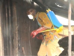 A humanitarian worker disinfects homes in Idabato, Cameroon, Nov. 28, 2019. (Moki Edwin Kindzeka/VOA)