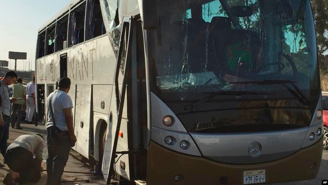 Officials jack up a bus that was damaged by a bomb, in Cairo, Egypt, Sunday, March 19, 2019. Egyptian officials say a roadside bomb has hit a tourist bus near the Giza Pyramids.