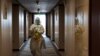 A staff worker disinfects a hotel floor inside the Olympic "closed-loop" during the Beijing 2022 Winter Olympics in Beijing, China, Feb. 8, 2022. 