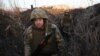 Servicemen of Ukrainian Military Forces walk along tranches on their position on the front line with Russia backed separatists, near Novognativka village, Donetsk region, Feb. 21, 2022. 