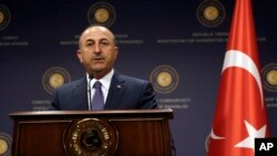 FILE - Turkey's Foreign Minister Mevlut Cavusoglu speaks during a news conference with German Foreign Minister Sigmar Gabriel in Ankara, Turkey, June 5, 2017.