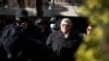 Golden Dawn party leader Nikos Michaloliakos, center, leaves his residence in Athens, Greece, Oct. 22, 2020.