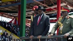 FILE - South Sudan's President Salva Kiir, center, accompanied by then-Army Chief of Staff Paul Malong, right, attends an independence day ceremony in the capital, Juba, July 9, 2015. 