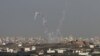 Trails of smoke are seen after the launch of rockets from the northern Gaza strip towards Israel, November 11, 2012. 