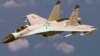 A Chinese J-11 fighter jet is seen flying near a U.S. Navy P-8 Poseidon about 215 km (135 miles) east of China's Hainan Island in this U.S. Department of Defense handout photo taken Aug. 19, 2014. 