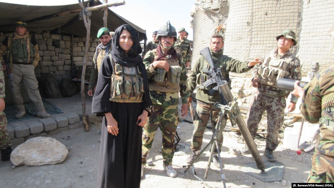 Afghan National Army troops accompany a VOA team, including reporter Ayesha Tanzeem, to a police checkpoint in Achin, a district in eastern Afghanistan. (R. Sarwan/VOA News)