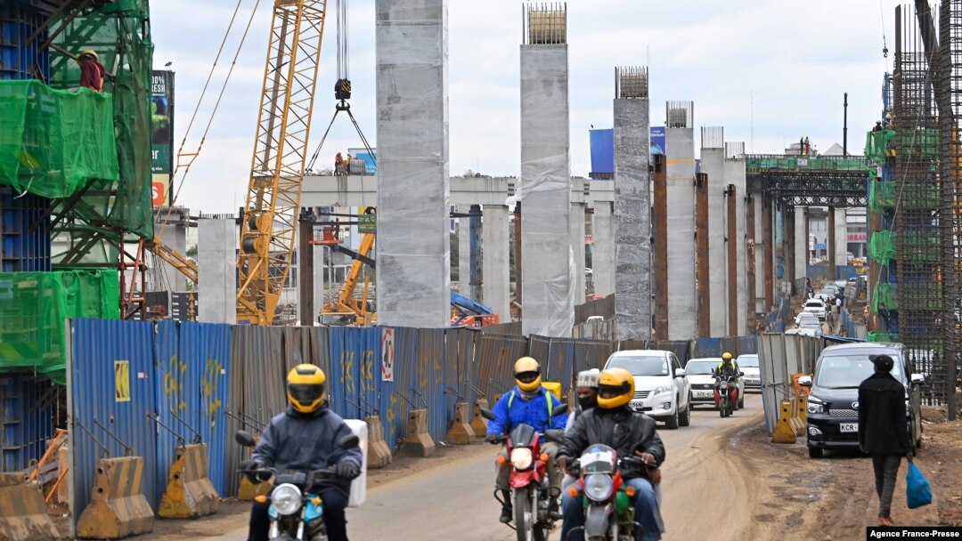 Motorists drive on Mombasa road, next to the ongoing construction site of the Nairobi Expressway, undertaken by the Chinese contractor China Road and Bridge Corporation (CRBC), in Nairobi, Kenya, July 12, 2021.