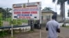 FILE - A man walks past the entrance of the bilingual Lycee of Buea, capital of south west Cameroon, one of the two regions of the country in the grip of a violent crisis, Sept. 24, 2019.