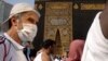 A relatively few number of Muslims pray around the Kaaba, the cubic building at the Grand Mosque, in the Muslim holy city of Mecca, Saudi Arabia, Thursday, March 5, 2020.