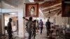Amhara Fano militia fighters walk in the ransacked terminal at the Lalibela airport in Lalibela, Ethiopia, Dec. 7, 2021.