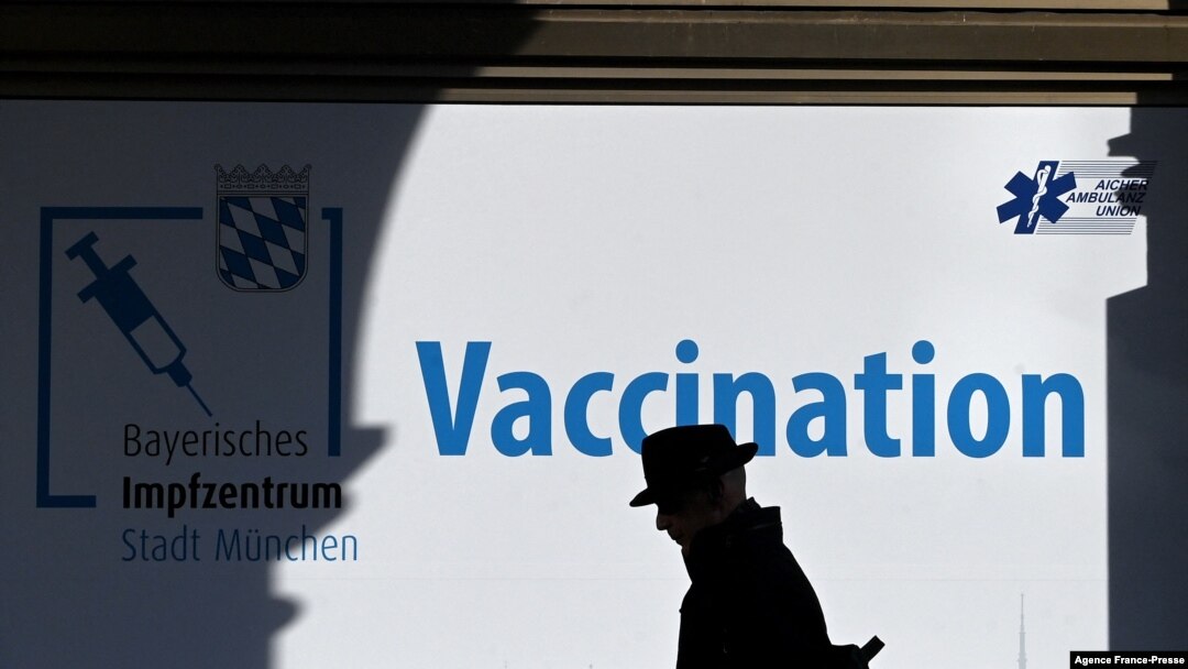 A man walks in front of a vaccination center in the city of Munich, Germany, Nov. 11, 2021, amid a surge of infections during the ongoing COVID-19 pandemic. 