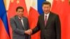FILE - Chinese President Xi Jinping, right, shakes hands with Philippines President Rodrigo Duterte before their bilateral meeting during the Belt and Road Forum, Beijing, May 15, 2017.