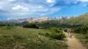 Hikers enjoy the Ute Trail, taking in the view of the alpine tundra and Never Summer Mountains.