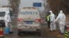 Workers disinfect passing vehicles in an area after the latest incident of African swine flu outbreak on the outskirts of Beijing, China, Friday, Nov. 23, 2018.