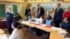 FILE - Teacher Yvette Rainville, of the Vermont Refugee Resettlement Program, instructs students in an English-language class on the basics of traffic signs as others - including Vermont Gov. Peter Shumlin, standing at right - observe, in Burlington, Vermont, Nov. 24, 2015.