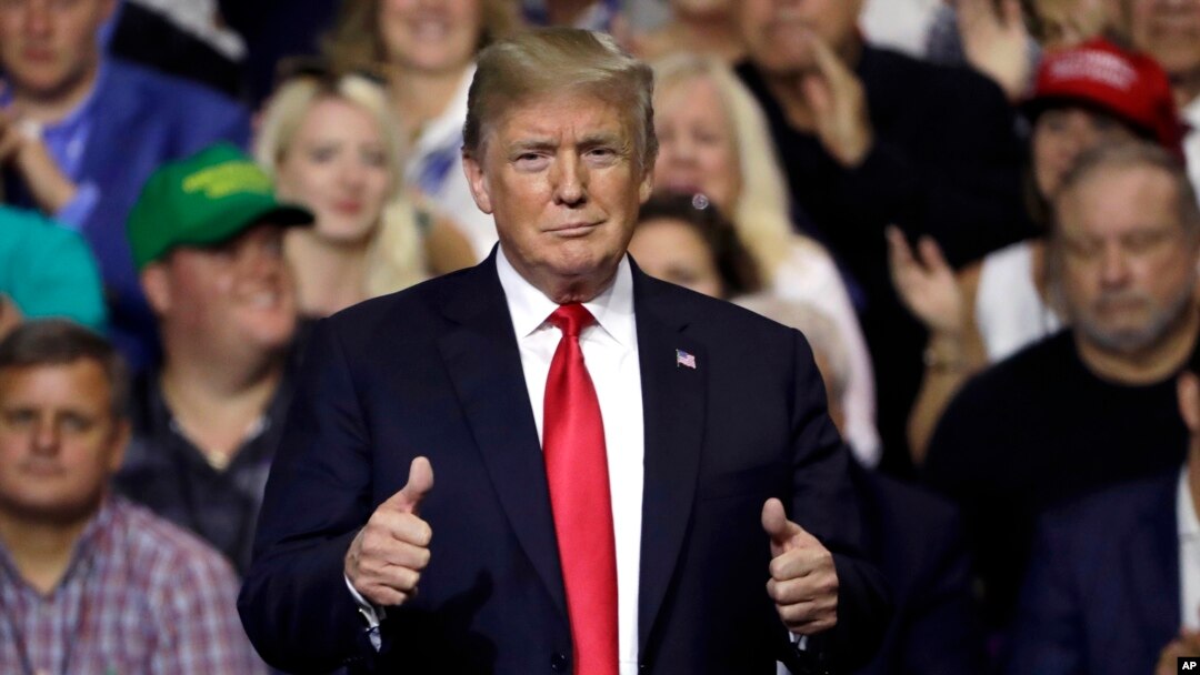 FILE - President Donald Trump gestures during a rally in Tampa, Fla., July 31, 2018.