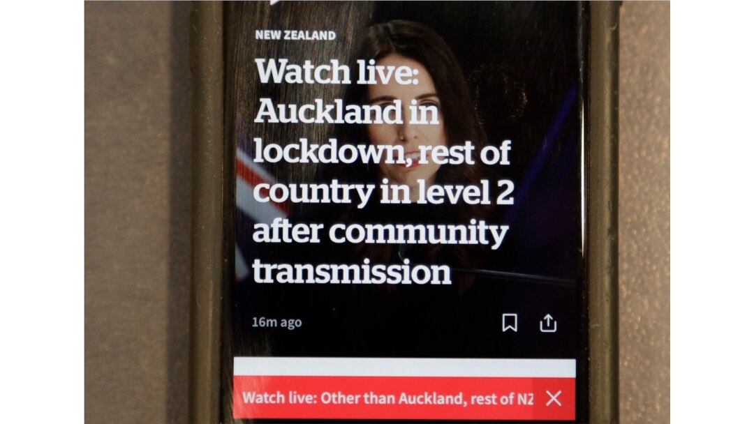 A news alert is displayed on a mobile phone in Christchurch, New Zealand, Aug. 11, 2020.