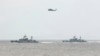 FILE - A Taiwan Navy helicopter flies over two Taiwan made corvettes during a navy exercise in the bound of Suao naval station in Yilan County, northeast of Taiwan, Apr. 13, 2018. 