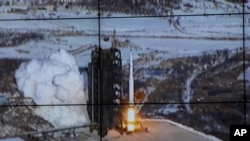 Image taken and released by the Korean Central News Agency and distributed in Tokyo by the Korea News Service, the Unha-3 rocket lifts off from a launch site on the west coast, in the village of Tongchang-ri, about 56 kilometers (35 miles) from the Chines