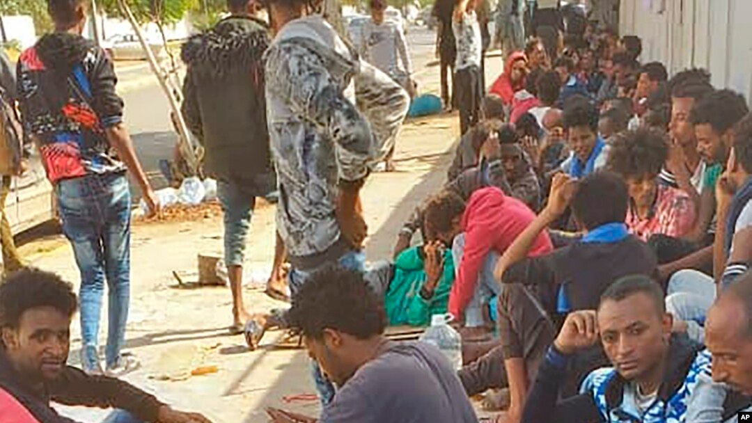 Hundreds of migrants who fled a detention center in coastal Libya crowd around a U.N. facility in Tripoli, Libya, Oct. 30, 2019. 