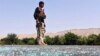 An Afghan soldier keeps watch at a glass-strewn post during clashes with Islamic State militants in the Kot district of Nangarhar province, Afghanistan, June 26 2016. 
