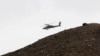 FILE - A U.S. Apache helicopter flies over Nangarhar province in April 2013. Iran said U.S. helicopters have been found transporting IS members from eastern Afghan to unknown locations.