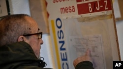 A man checks a panel at a polling station before casting his vote for the general election in Pamplona, northern Spain, Nov. 10, 2019. 