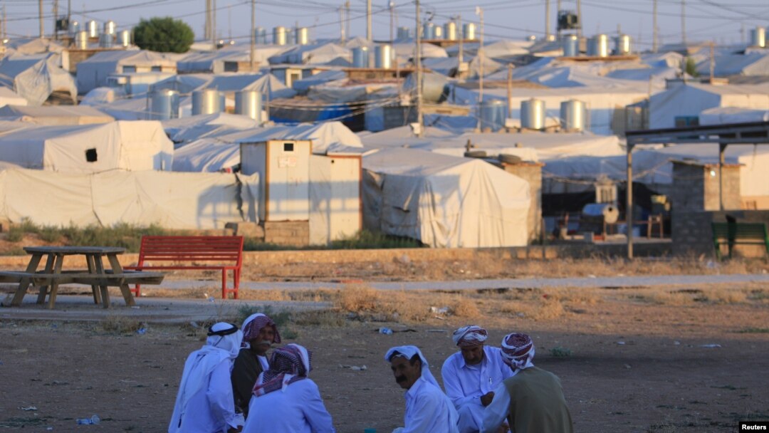 Displaced Iraqi men from the minority Yazidi sect, who fled the Iraqi town of Sinjar, are seen at the Khanki camp on the outskirts of Dohuk province, July 31, 2019. 