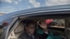 Cameroonian opposition leader Maurice Kamto sits in the back of a car as he is driven away on Oct. 5, 2019, the day of his release from prison in Yaounde.