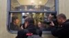 FILE - Musician Markus Rindt a 1989 German refugee is surrounded by media after boarding a train in Prague, Czech Republic, Oct. 1, 2009.