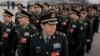 Delegates from China's People's Liberation Army (PLA) stand in line as they arrive at the Great Hall of the People to attend a session of National People's Congress in Beijing, March 4, 2016.