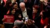 The leader of Britain's opposition Labour party Jeremy Corbyn poses with supporters after his speech at a rally to demand the government introduce an emergency budget for the National Health Service (NHS) to end a winter crisis, at Methodist Central Hall in London, Thursday, Jan. 25, 2018.