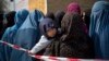 Afghan women in line queuing to get their registration cards on the last day of voter registration for the presidential elections, April 1.