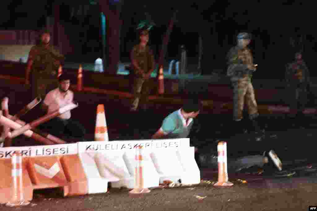 Turkish security officers detain unknown individuals on the side of the road July 15, 2016, in Istanbul, during a security shutdown of the Bosphorus Bridge.