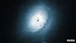 NASA/ESA Hubble Space Telescope view of the dust disc around the young star HD 100546. (ESO/NASA/ESA/Ardila et al.)