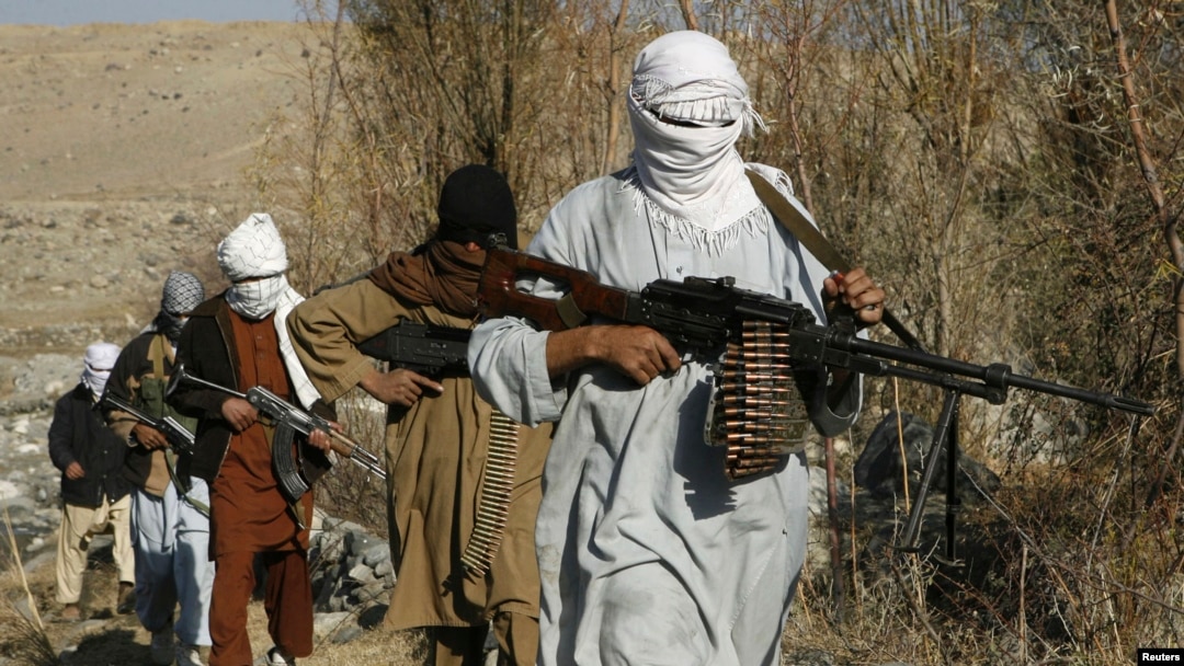 FILE - Armed Taliban fighters are seen at an undisclosed location in Nangarhar province, Afghanistan, Dec.13, 2010. 