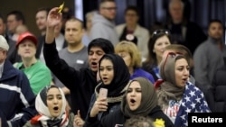 FILE - Young Muslims protest U.S. Republican presidential candidate Donald Trump before being escorted out during a campaign rally in Wichita, Kansas, March 5, 2016.