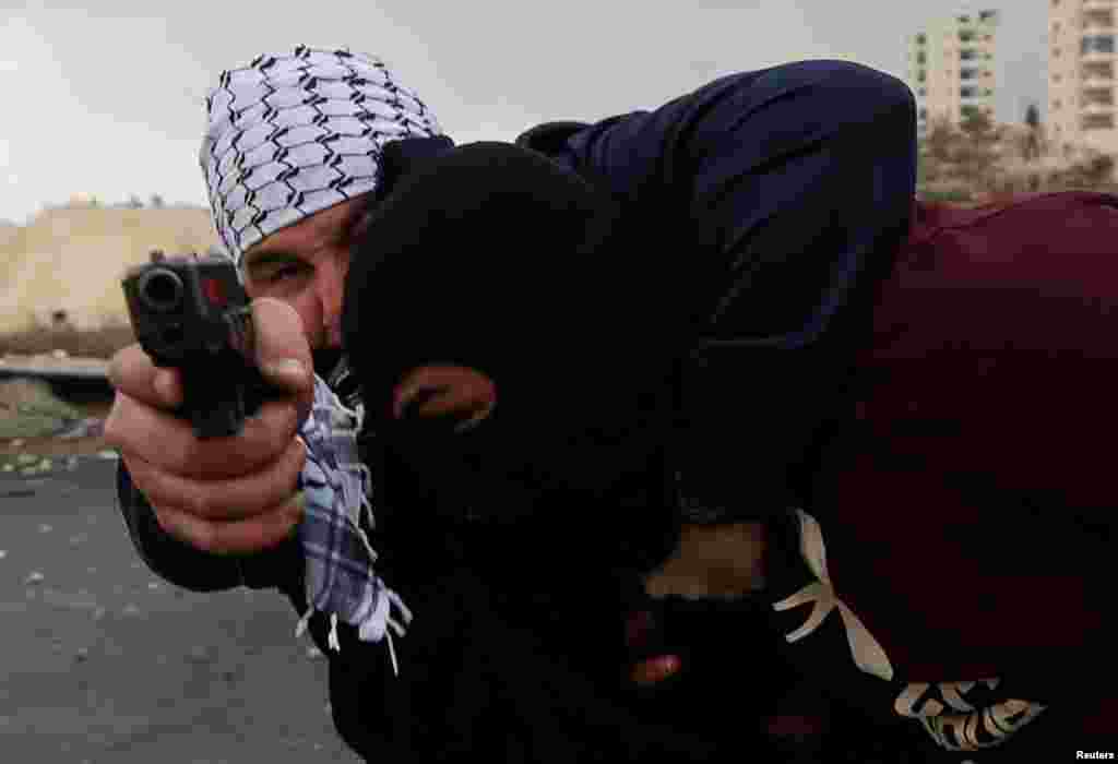 An undercover Israeli security personnel detaind a Palestinian demonstrator during clashes at a protest against U.S. President Donald Trump's decision to recognize Jerusalem as the capital of Israel, near the Jewish settlement of Beit El, near the West Bank city of Ramallah.