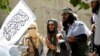 FILE - Members of the Taliban celebrate the cease-fire in Ghanikhel district of Nangarhar province, Afghanistan, June 16, 2018.