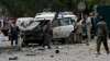 Afghan policemen investigate the site of a suicide attack in Kabul, June 6, 2014.