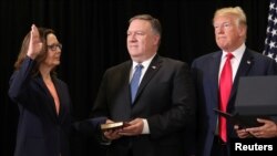 Gina Haspel is sworn in as the new U.S. CIA director as Secretary of State Mike Pompeo holds the bible and President Donald Trump looks on during ceremonies at the headquarters of the Central Intelligence Agency in Langley, Virginia, May 21, 2018.