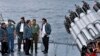 In this June 23, 2016 file photo released by the Indonesian Presidential Office, Indonesian President Joko Widodo, third right, accompanied by Indonesian officials on navy warship KRI Imam Bonjol, at the Natuna Islands, Indonesia.